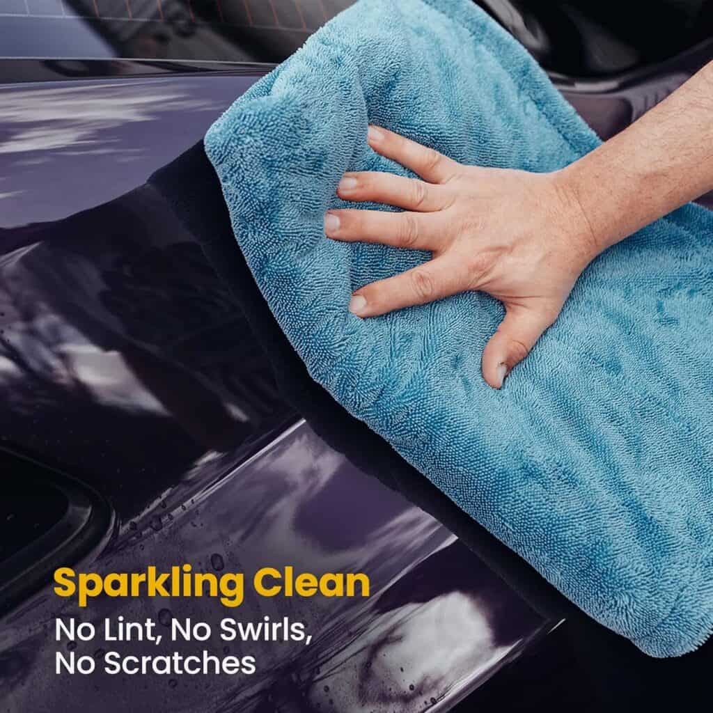 Blue 1200 GSM microfiber towel being used to dry car after wash