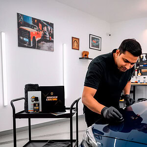 Professional car detailing with super ceramic coating for superior protection and shine.